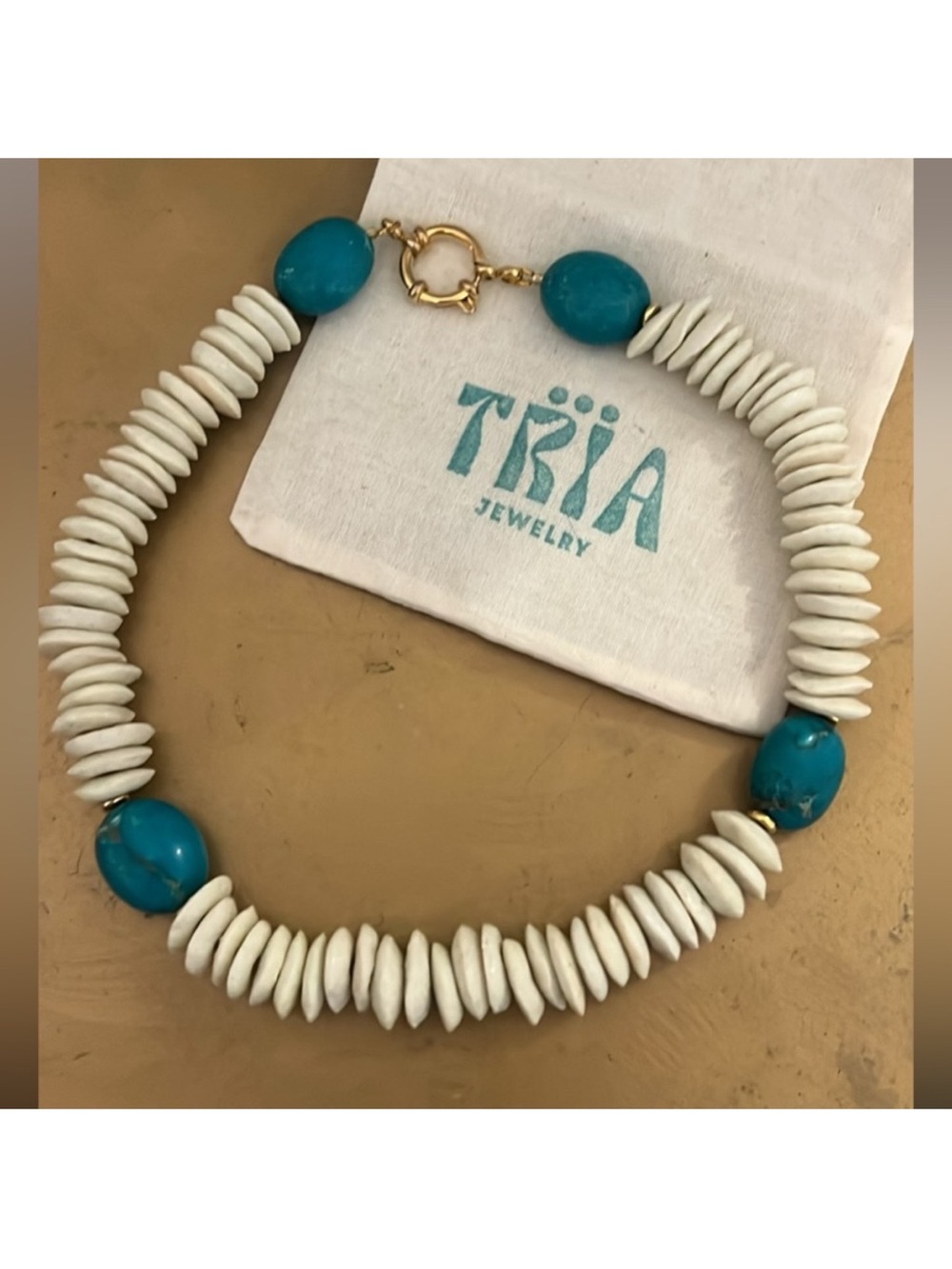 African head and turquoise necklace